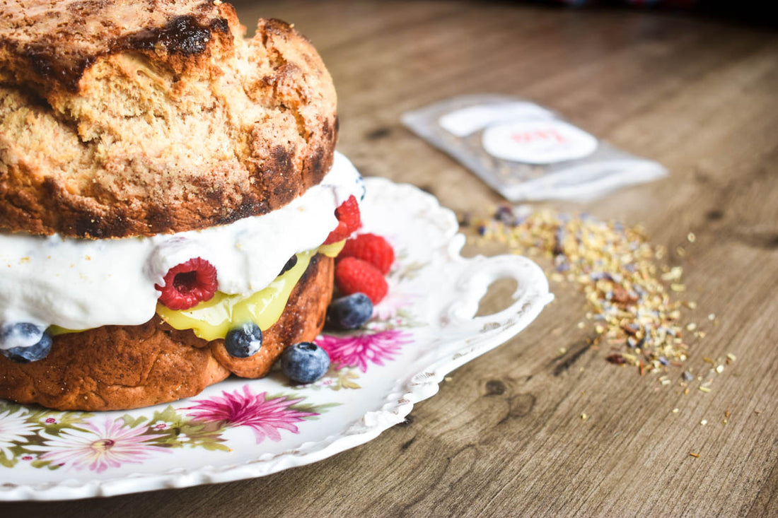 Try this indulgent tea-infused scone cake, fresh berries, zippy lemon curd, and homemade blueberry vanilla whipped cream, paired with your favorite fruit tea!